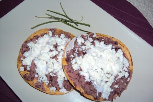 Tostadas de frijoles con queso fresco y crema